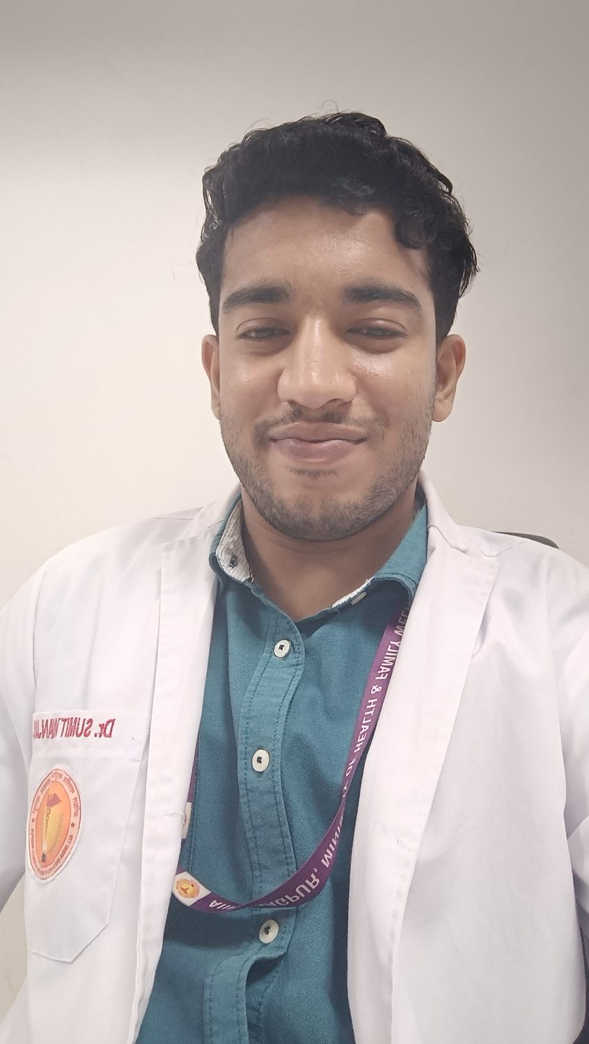 Sumit in a white coat in the evening.